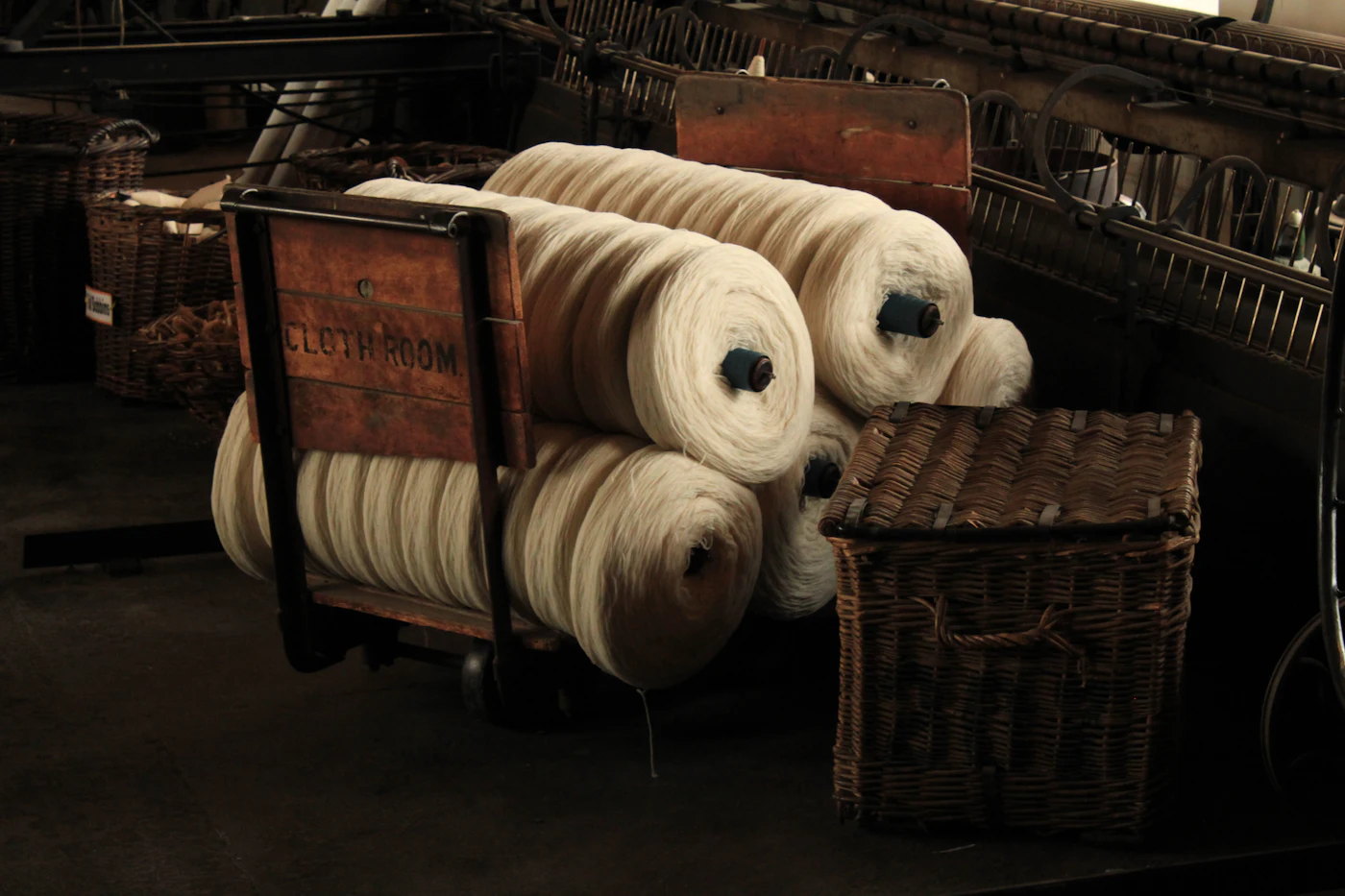 Cones of undyed wool on a trolley in the mill